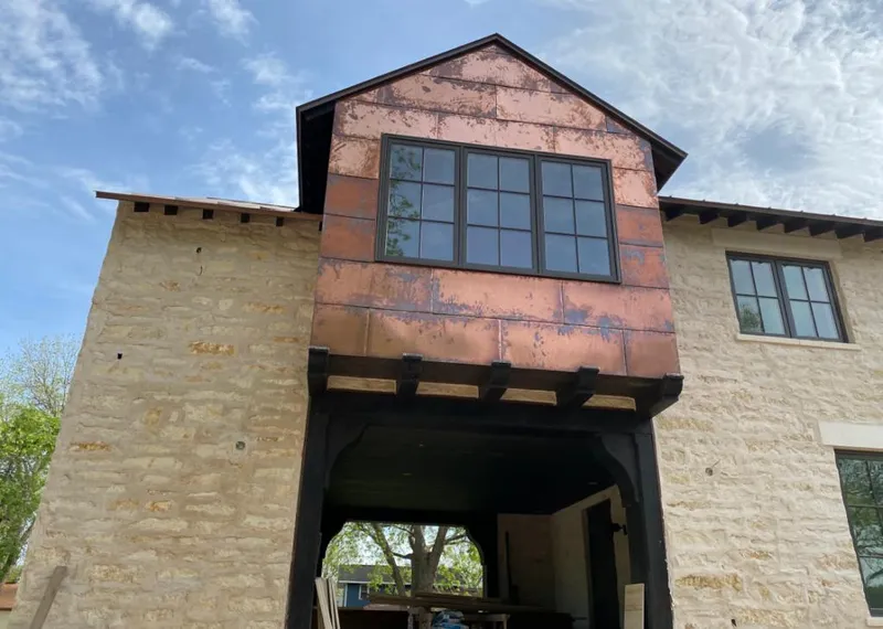 Copper metal panel facade on a stone building for Skylight Installation in Ensley
